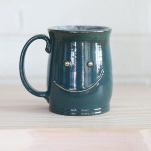 Teal happy mug - mischievous expression